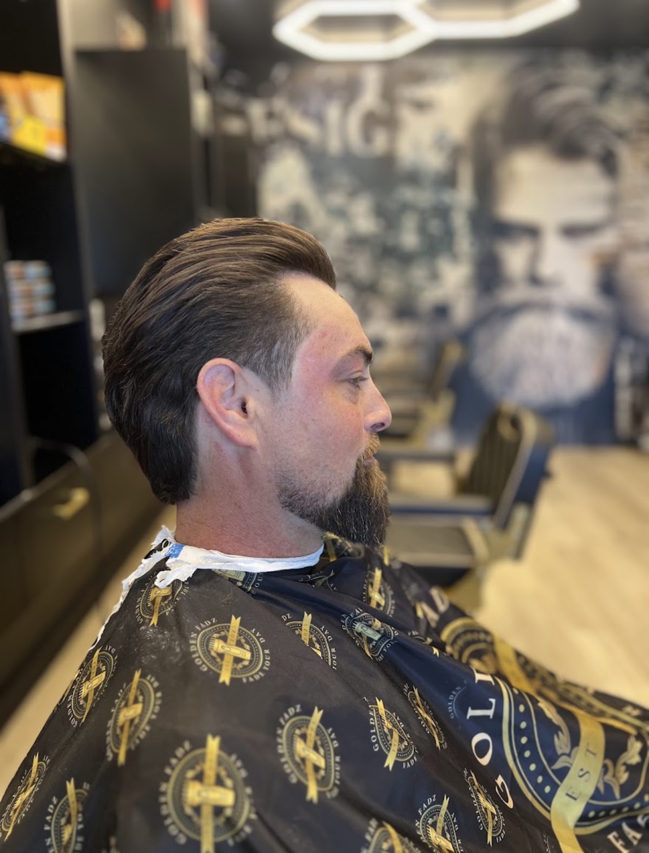 Slicked-back taper with a shaped full beard, cut at Golden Fadz Gosford